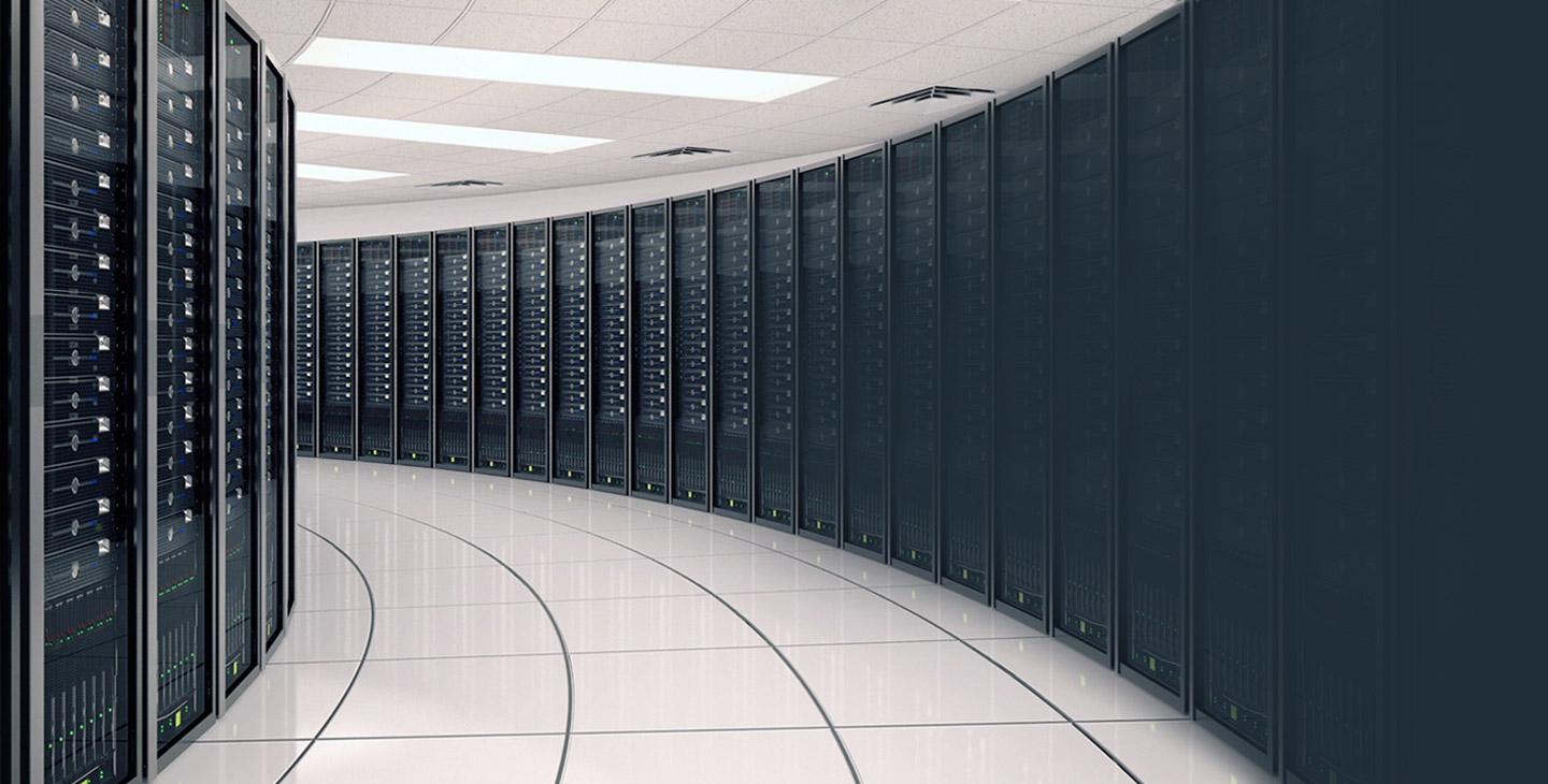 Hallway extending down a server room lined with black equipment on both sides